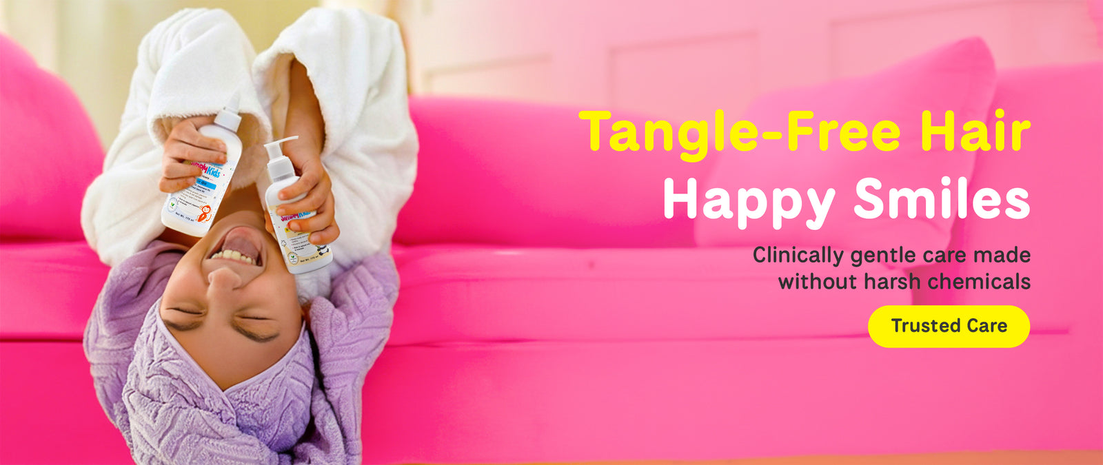 Home banner of kid holding the bottle -Tangle -free hair happy smiles